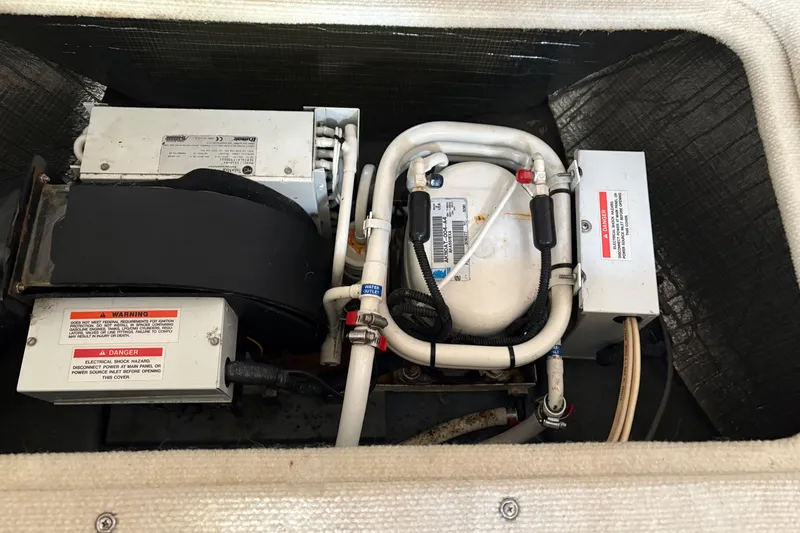 Slide: The Image of Engine compartment of a 2000 Sea Ray 340 Sundancer, showcasing mechanical components and wiring. - 21