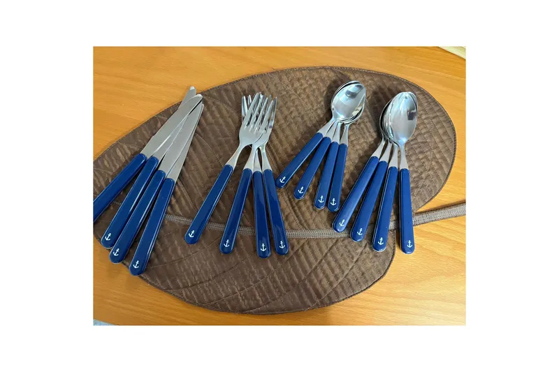 Slide: The Image of Blue-handled cutlery set with anchor design on a brown mat, Sea Ray 340 Sundancer 2000. - 24