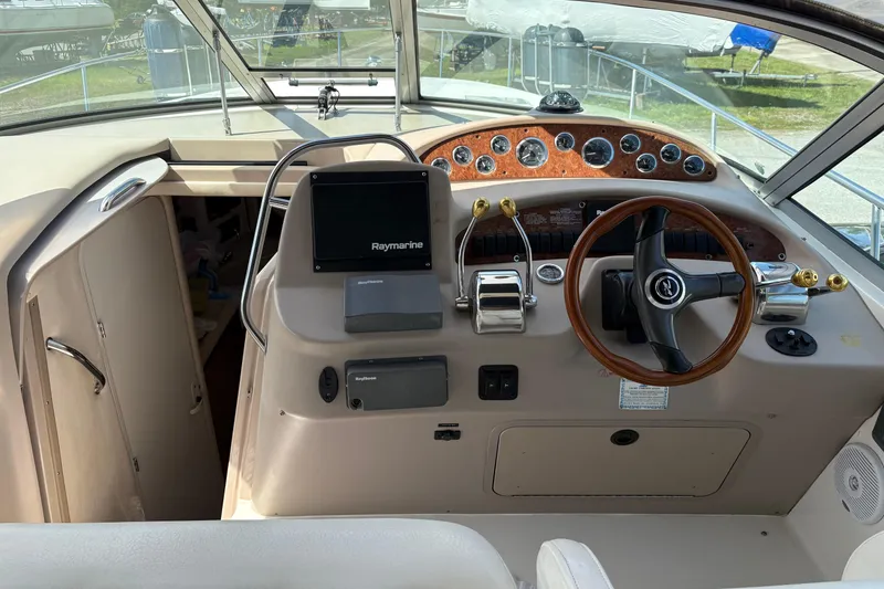 Slide: The Image of Cockpit of 2000 Sea Ray 340 Sundancer with steering wheel and navigation equipment. - 8