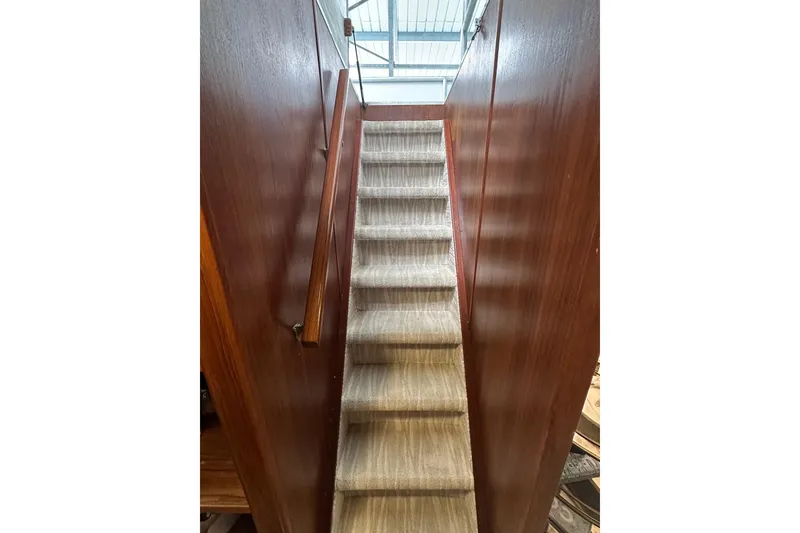 Slide: The Image of Carpeted stairs with wooden walls inside a 1997 Lazy Days 16x85 houseboat. - 13