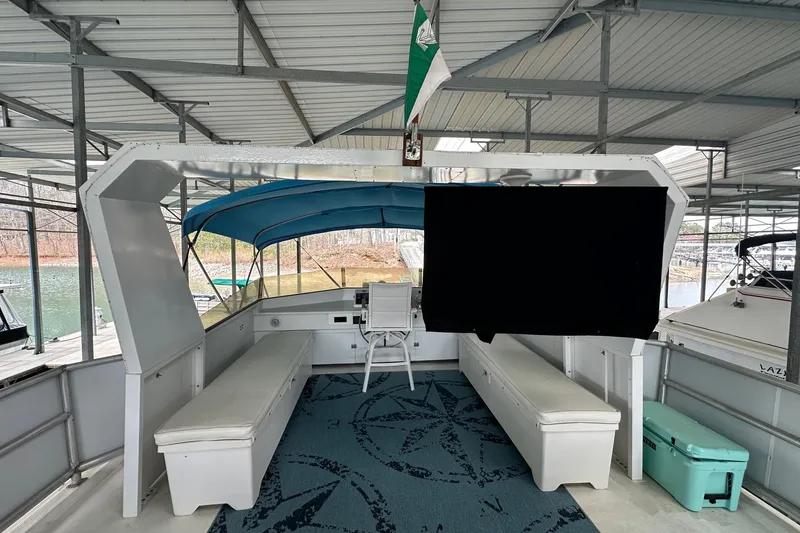 Slide: The Image of 1997 Lazy Days 16x85 houseboat interior with seating, canopy, and lake view. - 16
