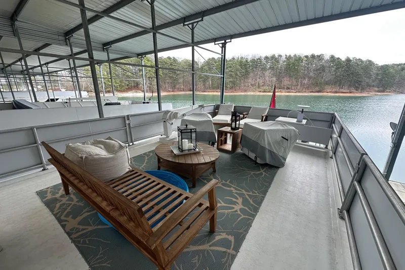 Slide: The Image of Covered deck on 1997 Lazy Days houseboat with lake view and outdoor seating. - 18