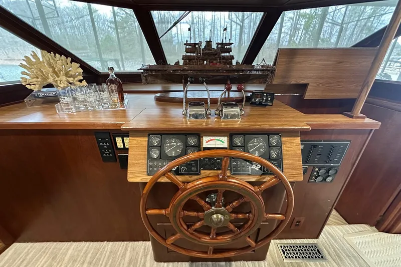 Slide: The Image of Wooden helm of a 1997 Lazy Days 16x85 houseboat with nautical decor. - 2