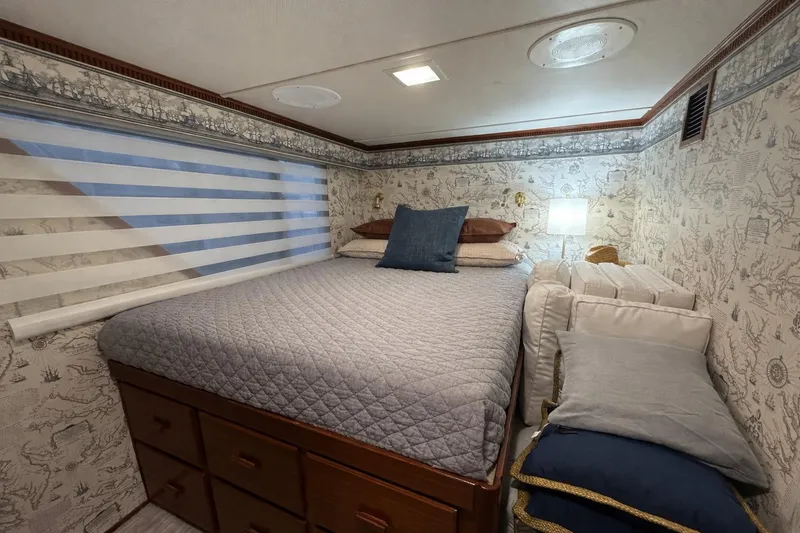 Slide: The Image of Cozy bedroom in 1997 Lazy Days 16x85 houseboat with nautical-themed wallpaper and striped blinds. - 6