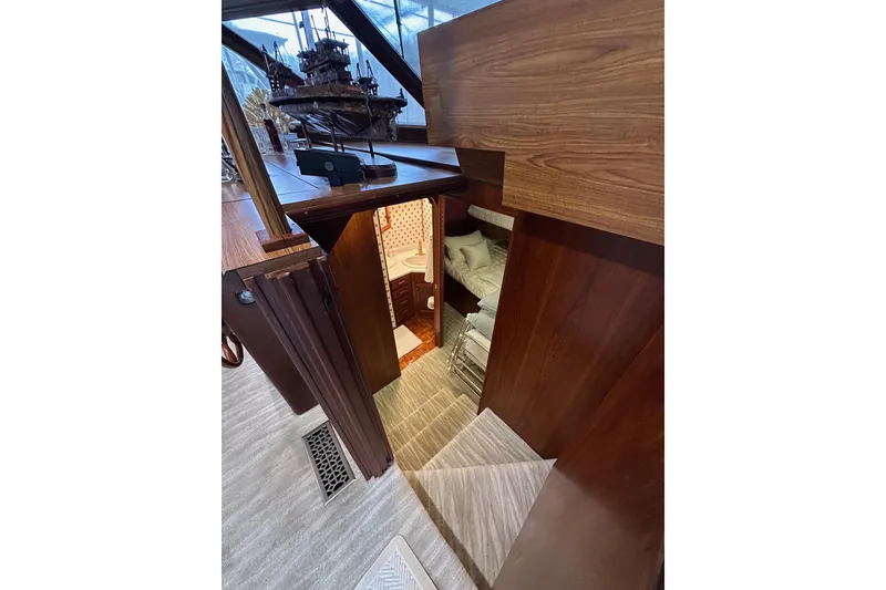 Slide: The Image of Interior of 1997 Lazy Days 16x85 houseboat with wooden stairs and cozy cabin. - 8