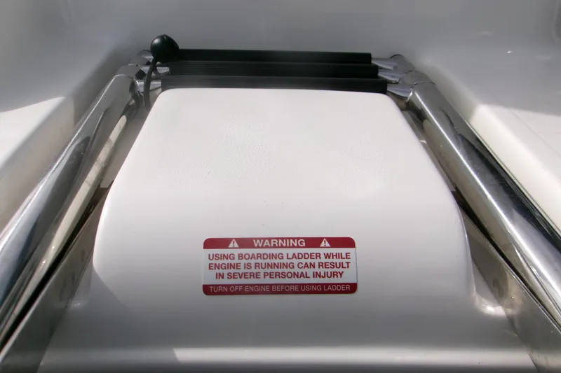Slide: The Image of Boarding ladder warning label on 2026 Key West 203 FS boat, emphasizing safety precautions. - 14