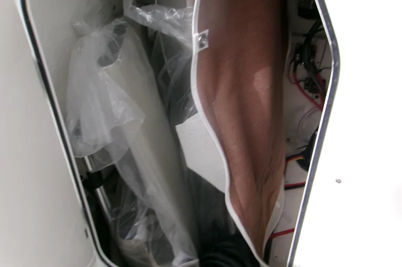 Slide: The Image of Storage compartment of 2026 Key West 203 FS boat, showing interior details and wiring. - 15