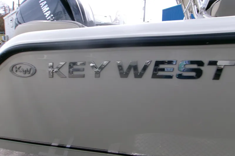 Slide: The Image of 2026 Key West 203 FS boat with chrome logo detail. - 16