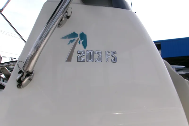Slide: The Image of 2026 Key West 203 FS boat emblem on white surface, showcasing sleek design. - 17