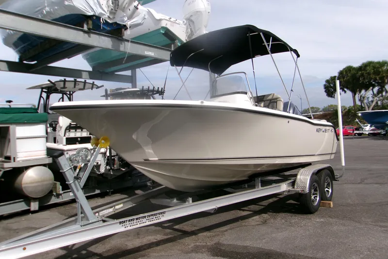 Slide: The Image of 2026 Key West 203 FS boat on trailer, parked outdoors with canopy. - 18