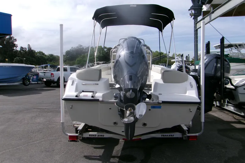 Slide: The Image of 2026 Key West 203 FS boat on trailer, rear view with outboard motor. - 3