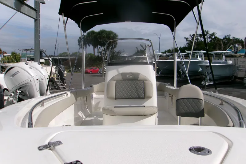 Slide: The Image of 2026 Key West 203 FS boat interior with seating and canopy in a marina setting. - 9