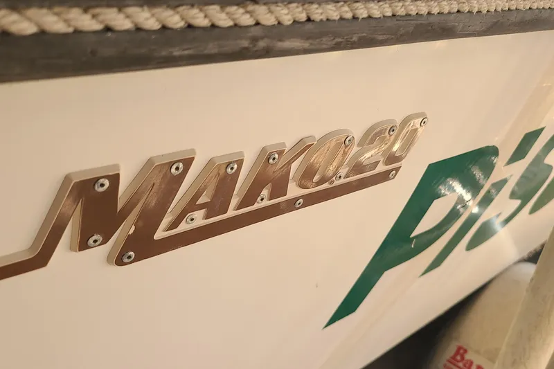 The Image of 1983 Mako 20 Center Console boat emblem with metallic lettering detail. - 0