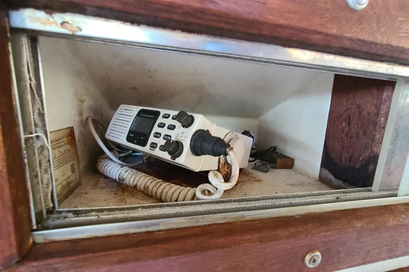 Slide: The Image of Old marine radio in a 1983 Mako 20 Center Console storage compartment. - 12