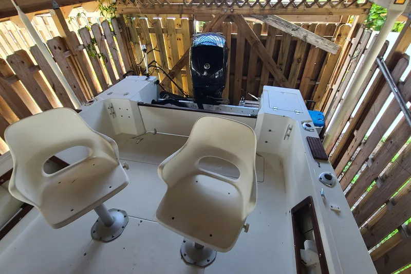 Slide: The Image of 1983 Mako 20 Center Console boat interior with dual seats and outboard motor. - 15