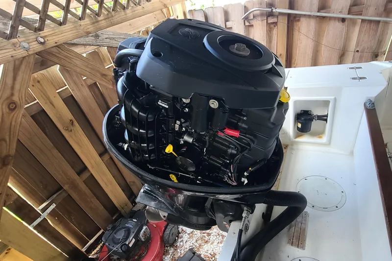 Slide: The Image of 1983 Mako 20 Center Console boat engine in a wooden enclosure. - 18