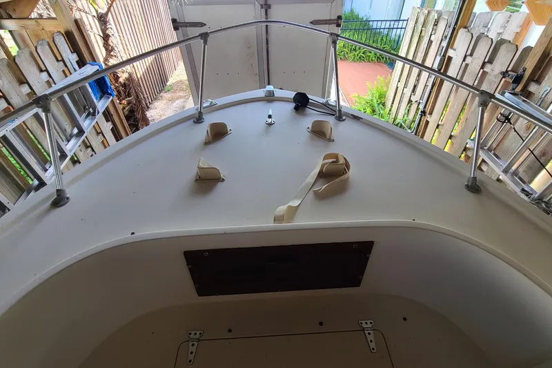 Slide: The Image of 1983 Mako 20 Center Console boat deck with railing and storage compartment. - 2