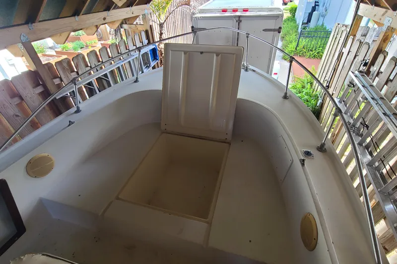 Slide: The Image of 1983 Mako 20 Center Console boat interior with open storage compartment. - 4