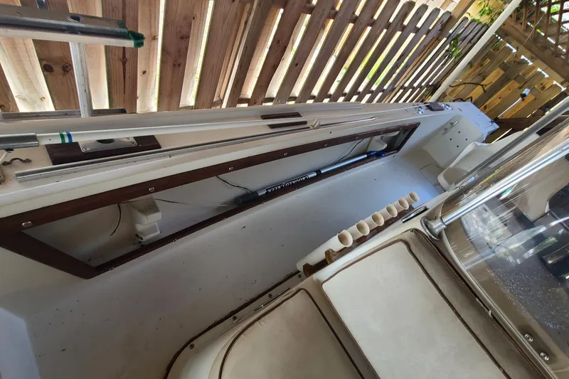 Slide: The Image of 1983 Mako 20 Center Console interior with rod holders and wooden accents. - 6