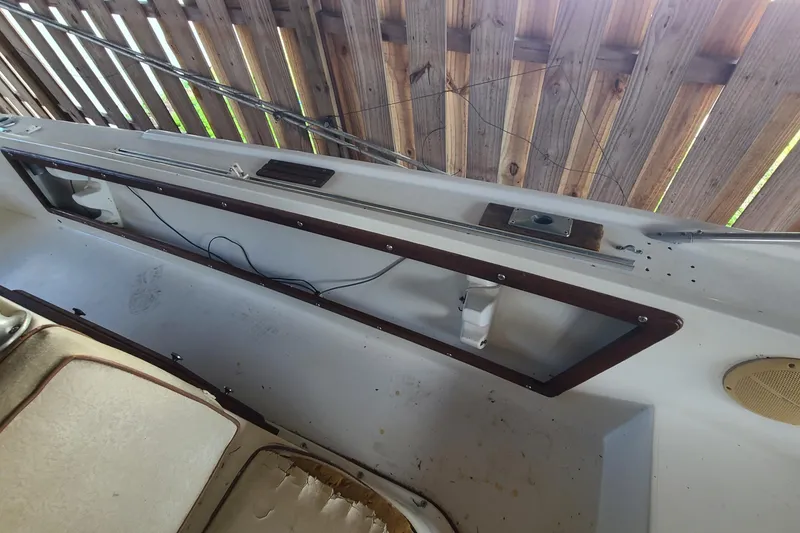 Slide: The Image of 1983 Mako 20 Center Console interior with wooden trim and visible wiring. - 7