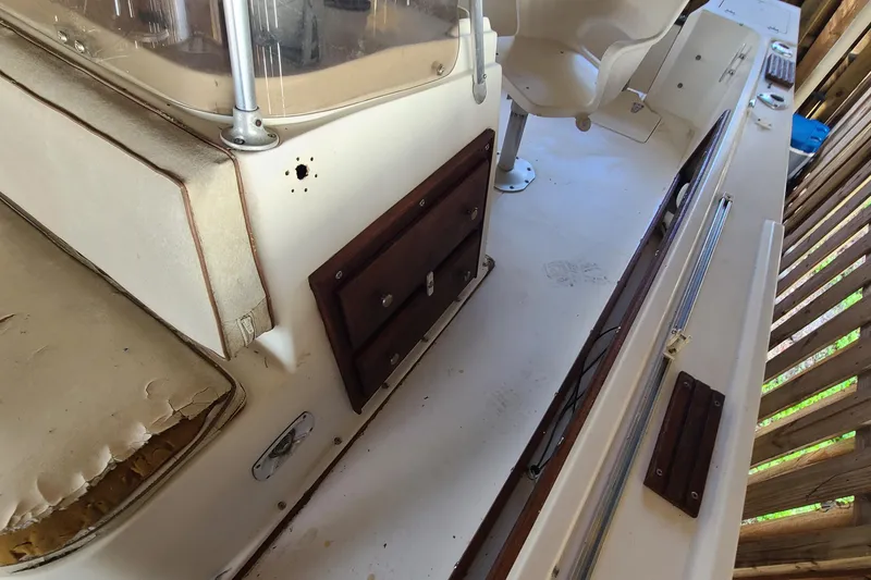 Slide: The Image of 1983 Mako 20 Center Console boat interior with seating and storage compartments. - 8