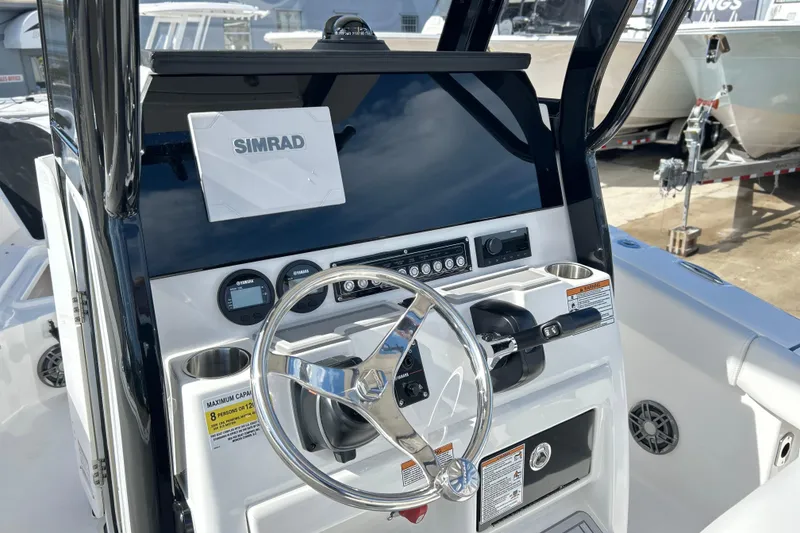 Slide: The Image of 2026 Sea Fox 228 Commander boat dashboard with Simrad display and steering wheel. - 10