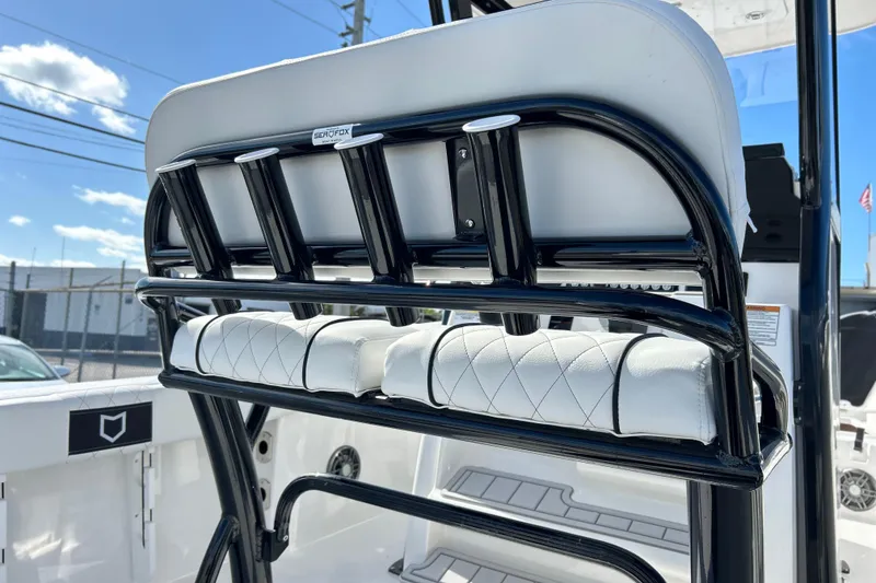Slide: The Image of 2026 Sea Fox 228 Commander boat seating with rod holders, featuring sleek black and white design. - 12