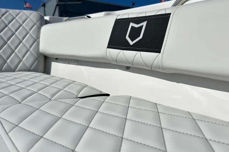 Slide: The Image of 2026 Sea Fox 228 Commander boat interior with quilted white seating and logo detail. - 17