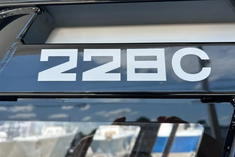 Slide: The Image of Close-up of 2026 Sea Fox 228 Commander boat model number on black surface. - 18