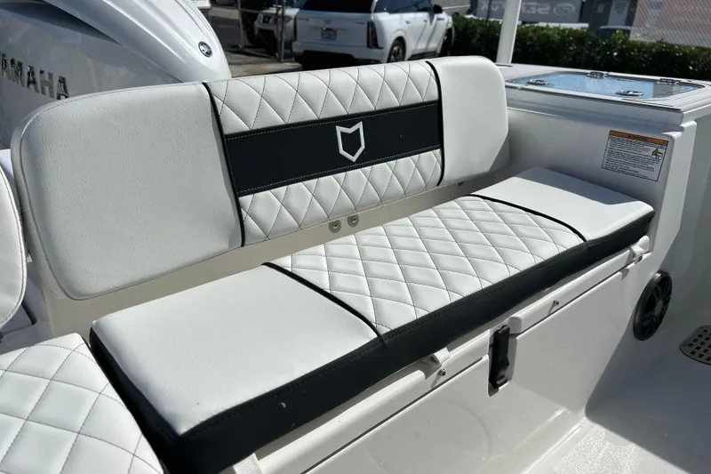 Slide: The Image of 2026 Sea Fox 228 Commander boat seat with diamond-stitched upholstery and storage compartment. - 24