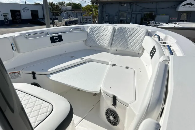 Slide: The Image of 2026 Sea Fox 228 Commander boat interior with white cushioned seating and storage compartments. - 3