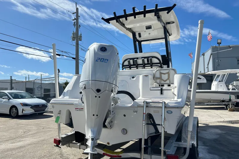 Slide: The Image of 2026 Sea Fox 228 Commander boat with Yamaha 200 engine, parked outdoors. - 34