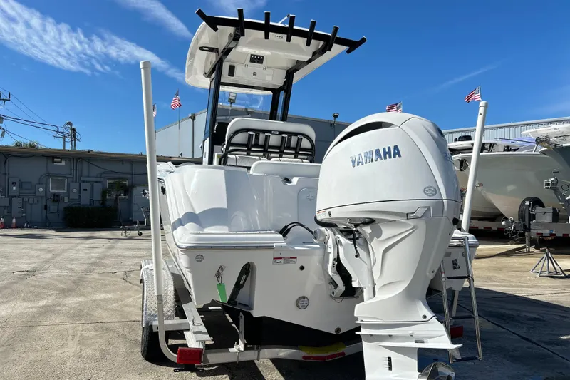Slide: The Image of 2026 Sea Fox 228 Commander boat with Yamaha engine, parked outdoors under clear blue sky. - 35