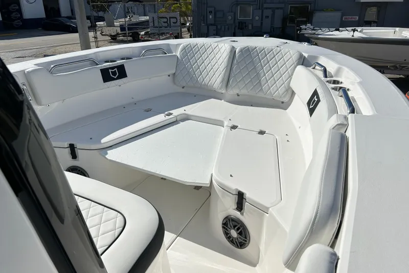 Slide: The Image of 2026 Sea Fox 228 Commander boat interior with white cushioned seating and table. - 4