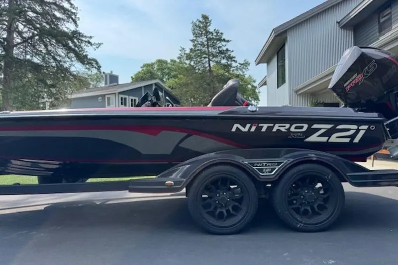 Slide: The Image of 2022 Nitro Z21 XL boat on trailer, parked in residential driveway. - 7