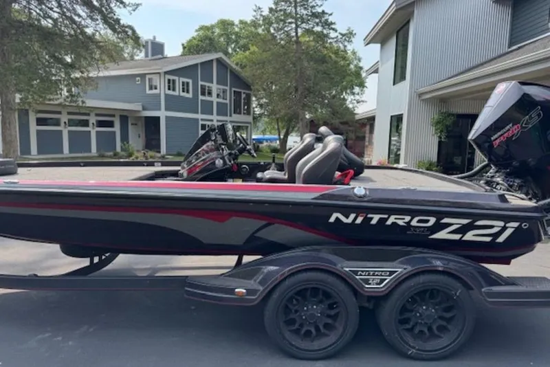 Slide: The Image of 2022 Nitro Z21 XL boat on trailer, parked in residential driveway. - 9