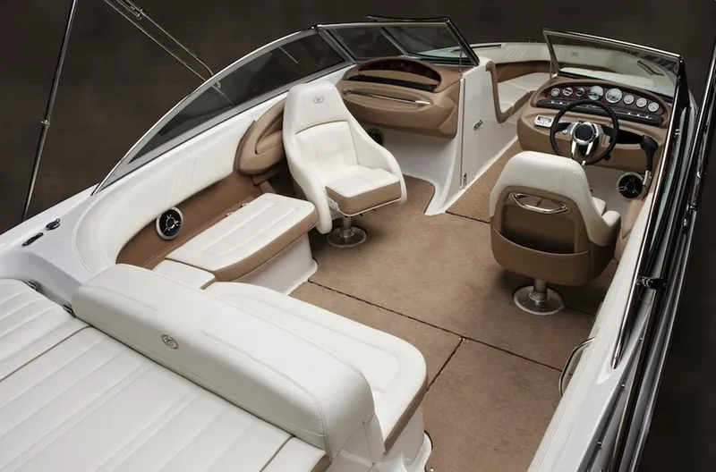 Slide: The Image of Manufacturer Provided Image: 2013 Cobalt 232 boat interior with white and tan seating, modern dashboard, and spacious layout. - 10