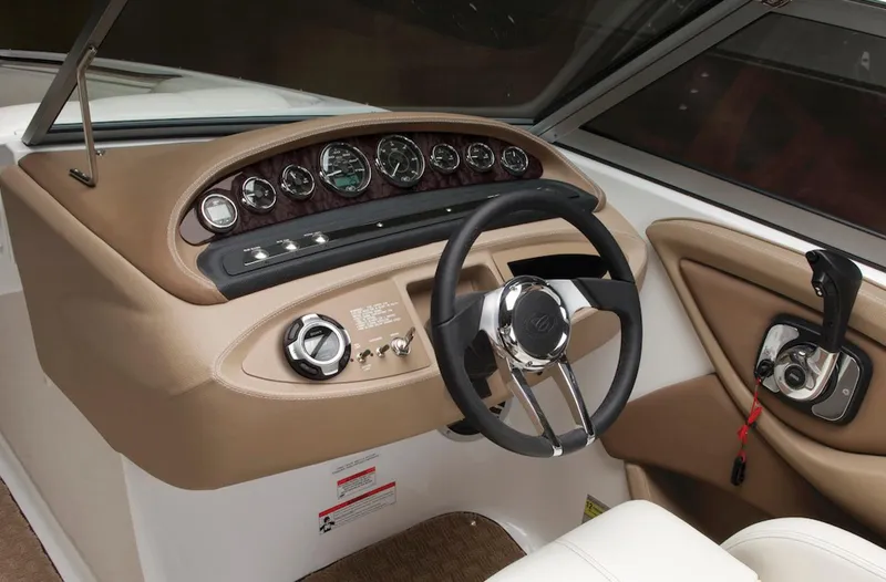 Slide: The Image of Manufacturer Provided Image: 2013 Cobalt 232 boat dashboard with steering wheel and control panel. - 11