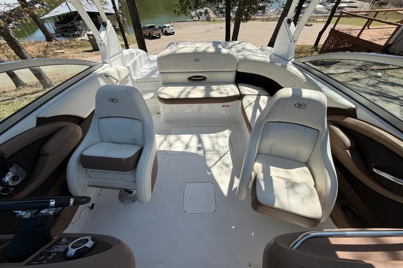 Slide: The Image of Interior of a 2013 Cobalt 232 boat with white and brown seating. - 13