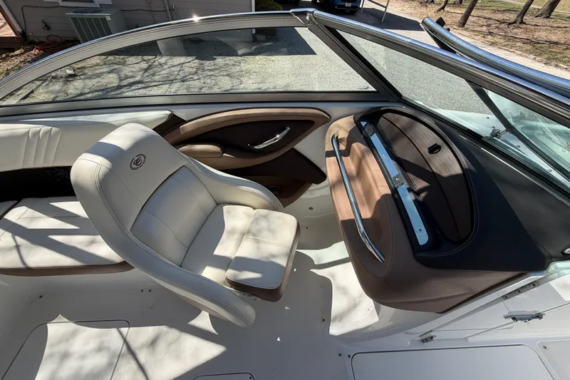 Slide: The Image of Interior of a 2013 Cobalt 232 boat with white and brown seating. - 14