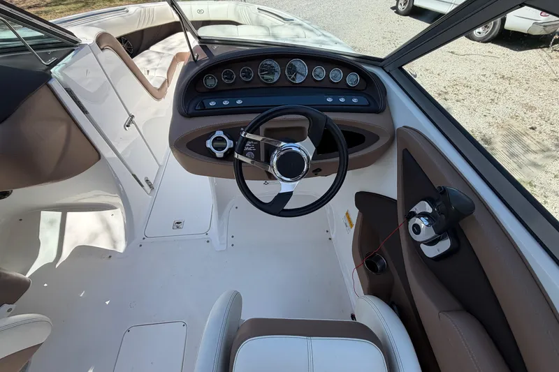Slide: The Image of Interior view of a 2013 Cobalt 232 boat cockpit with steering wheel and gauges. - 18