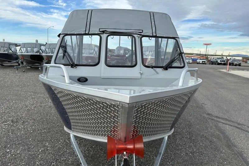 Slide: The Image of 2026 Hewescraft 160 Sportsman boat with aluminum hull, parked outdoors. - 10