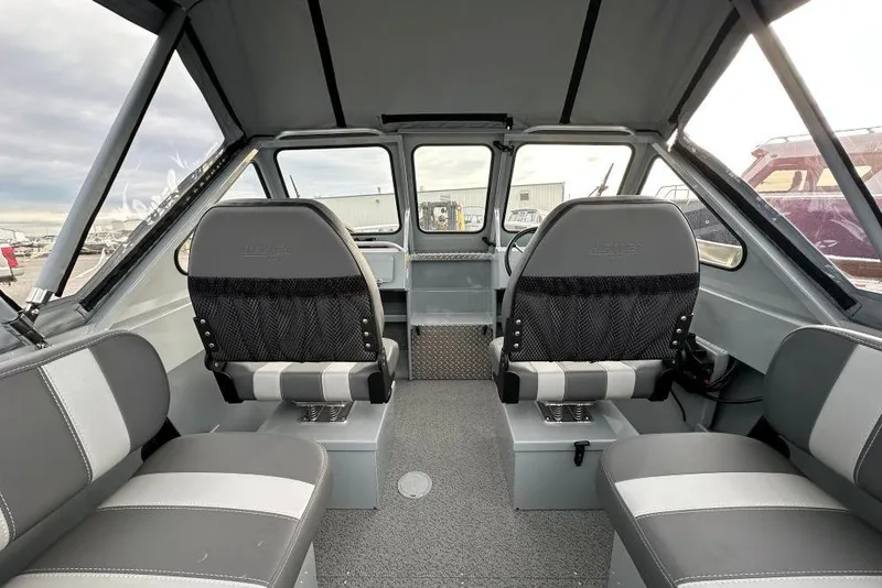 Slide: The Image of Interior of 2026 Hewescraft 160 Sportsman boat with seating and steering wheel. - 12