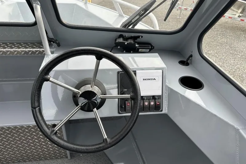 Slide: The Image of Steering wheel and controls of 2026 Hewescraft 160 Sportsman boat interior. - 13