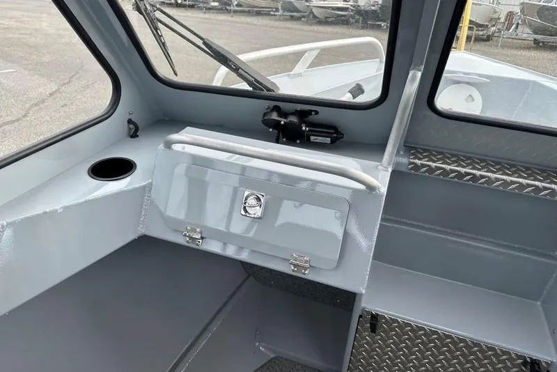 Slide: The Image of Interior of 2026 Hewescraft 160 Sportsman boat, featuring storage and windshield. - 14