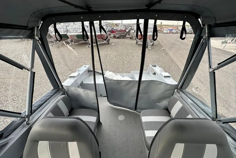 Slide: The Image of Interior view of 2026 Hewescraft 160 Sportsman boat with seating and canopy. - 15