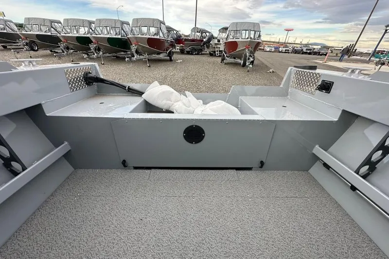 Slide: The Image of 2026 Hewescraft 160 Sportsman boat interior with multiple boats in the background. - 16