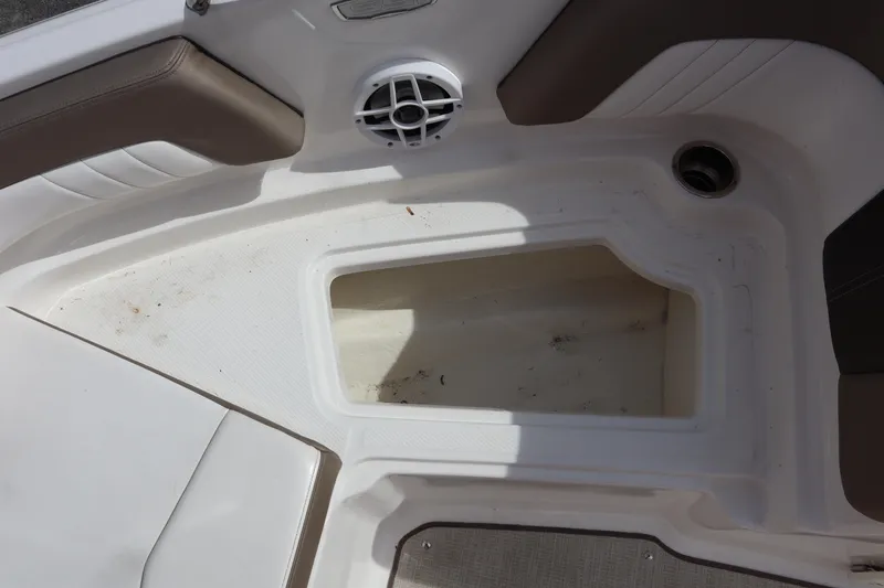 Slide: The Image of Interior storage compartment of a 2021 Chaparral 21 SSi boat with speaker and cup holder. - 13
