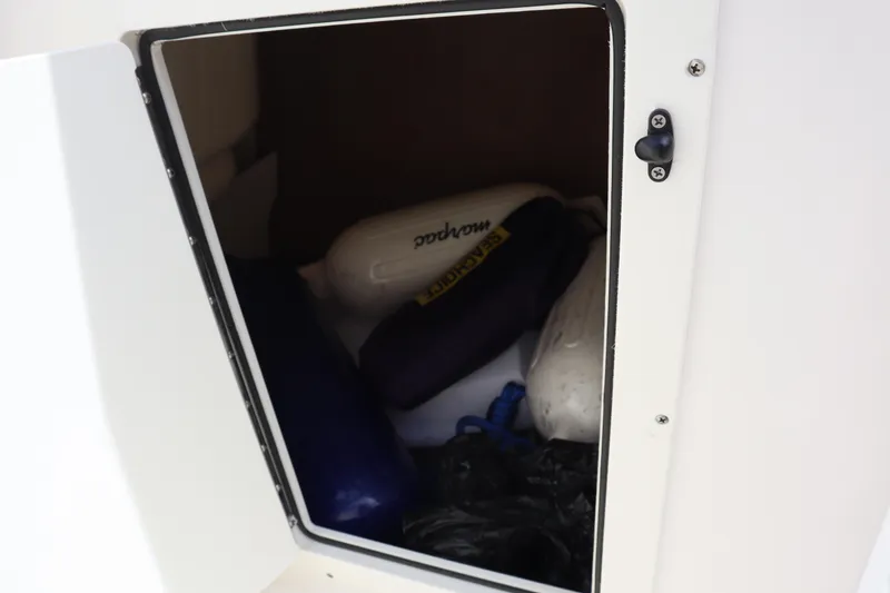 Slide: The Image of Storage compartment in 2021 Chaparral 21 SSi boat with fenders and equipment. - 17