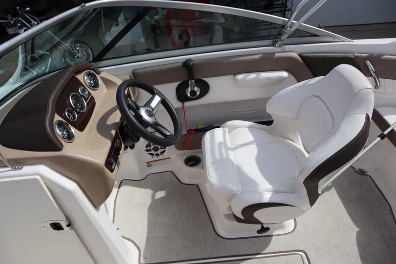 Slide: The Image of Interior of 2021 Chaparral 21 SSi boat with steering wheel and white captain's seat. - 18